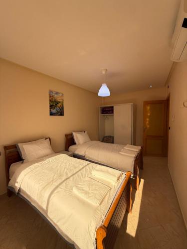 a bedroom with two beds in a room at Modern Apartment Driouch 1 in Driouch