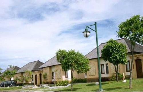 a house with a street light in front of it at Kalicaa Villa Resort, Tanjung Lesung in Tanjung Lesung