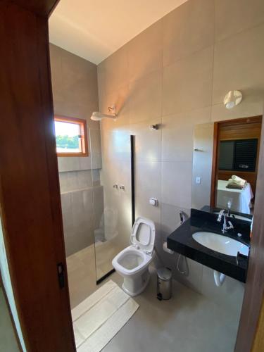 a bathroom with a toilet and a sink at Cerrado da Canastra Chalés in São Roque de Minas
