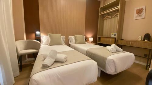 a hotel room with two beds and a mirror at Marina Boutique in Valencia