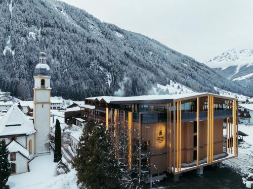 a glass house on top of a mountain at Hotel Kirchenwirt in Kaunertal