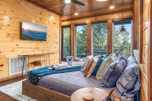 a bedroom with a bed in a log cabin at Gatlinburg Amazing Views-EV Chrger - Firepit, Spa Shower and Jacuzzi,Hot Tub in Gatlinburg