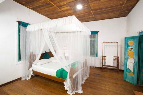 a bedroom with a bed with a canopy at Vihanga Village - Jungle retreat in Dambulla in Dambulla