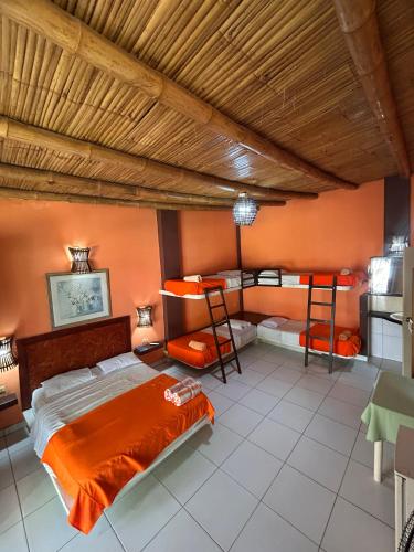 a bedroom with a bed and two bunk beds at Punta Pacífico Bungalows Máncora in Máncora