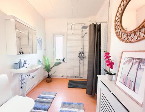 a bathroom with a sink and a shower at Prinshöjden Apartments & Villas - Katrineholm Residential in Katrineholm