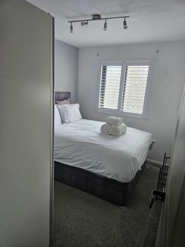 a bedroom with a bed with two towels on it at Flat 8 in Plymouth