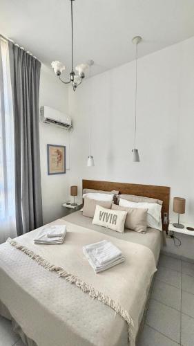 a bedroom with a large bed with two towels on it at V.60 in Nueve de Julio