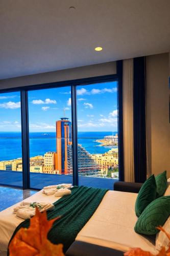 a bedroom with two beds and a view of the ocean at Whispering Waves at Mercury Tower with panoramic view , 2X pools and Gym in Paceville