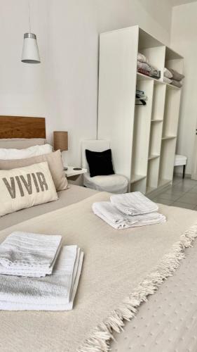 a bedroom with two beds with towels on them at V.60 in Nueve de Julio