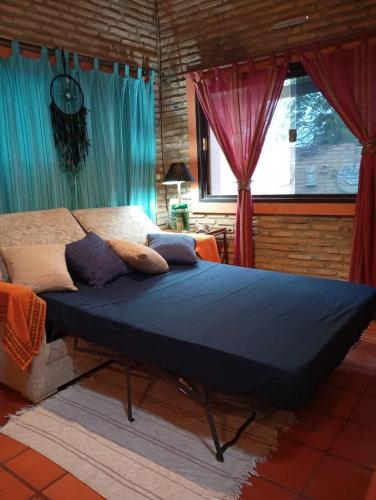 Llit o llits en una habitació de Mi Cottage Areguá
