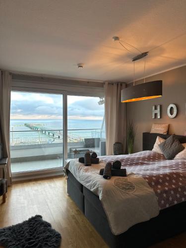 a hotel room with two beds and a large window at StrandSUITE Scharbeutz Meerblick in Scharbeutz