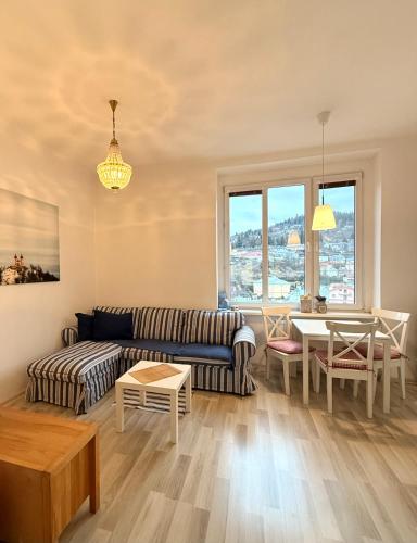 a living room with a couch and a table at Panoráma apartmán Centrum in Banská Štiavnica