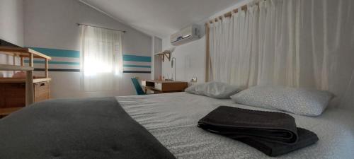 a bedroom with a bed with a hat on it at Villa with Private Pool & Hot tub in Fortuna