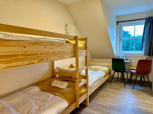 two bunk beds in a room with a table at Edinburgh full house in Edinburgh