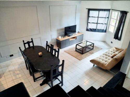 a living room with a table and a couch at Duplex familiar zona macrocentro in Resistencia