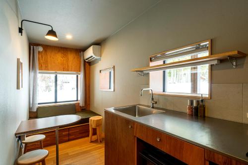 a kitchen with a sink and a counter top at B and D HAKUBA IWATAKE in Hakuba