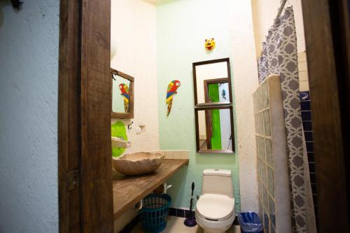 a bathroom with a toilet and a sink at La Selva by Majikal B&B in Mérida