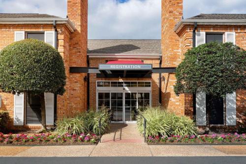 a brick building with a sign that reads reception at Extended Stay America Suites - Houston - Galleria in Houston
