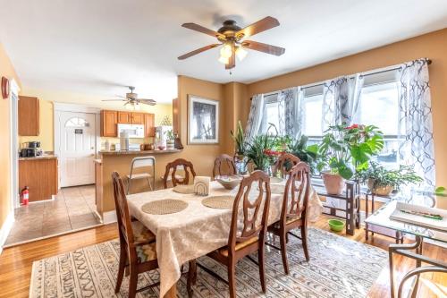 a kitchen and dining room with a table and chairs at The Paradise House steps from the Heart of Hertel in Buffalo