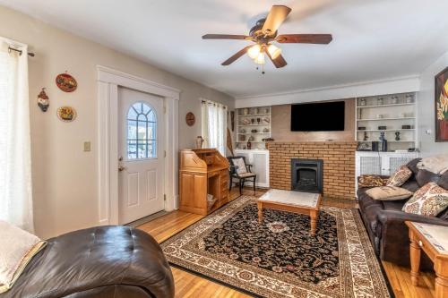 a living room with a ceiling fan and a fireplace at The Paradise House steps from the Heart of Hertel in Buffalo