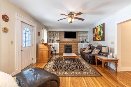 a living room with a couch and a fireplace at The Paradise House steps from the Heart of Hertel in Buffalo