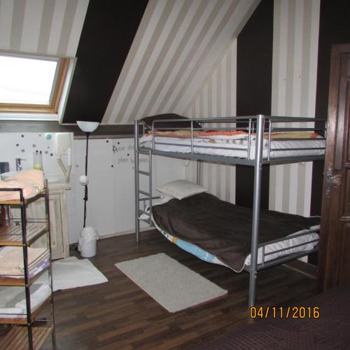 a dorm room with two bunk beds in it at La Grange in Vouzon