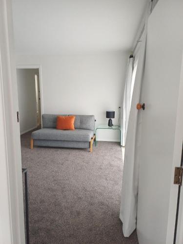 a living room with a couch and a table at Marigold in Manurewa in Auckland