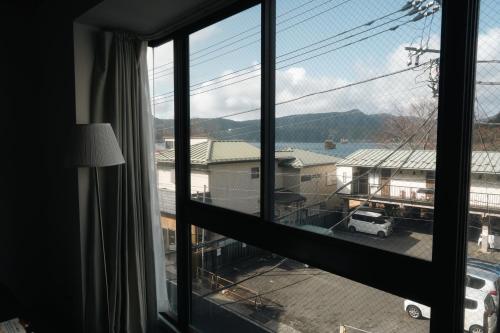 a window with a view of a parking lot at Ashinoko Port Villa MIRAHAKONE in Hakone
