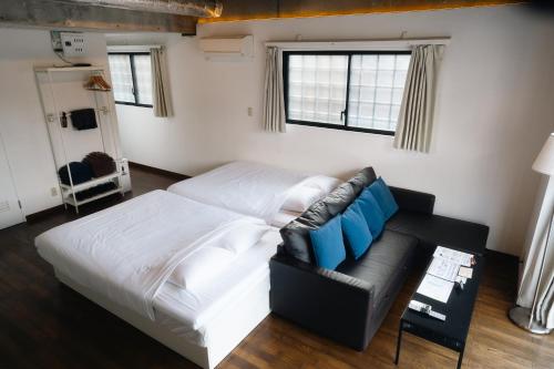 a living room with a bed and a couch at Ashinoko Port Villa MIRAHAKONE in Hakone