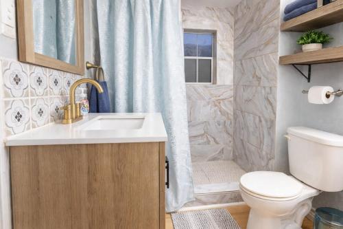 a bathroom with a sink and a toilet and a shower at Pool house , near downtown SA in San Antonio