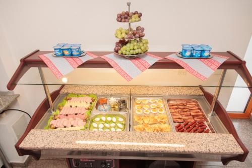 a display case with many different types of food at Plus Hotel in Craiova