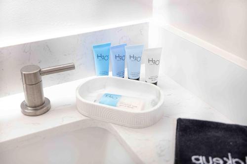 a bathroom counter with a sink and three tubes of toothpaste at Cozy apt 2 bedrooms 1 mile Universal Studios in Orlando