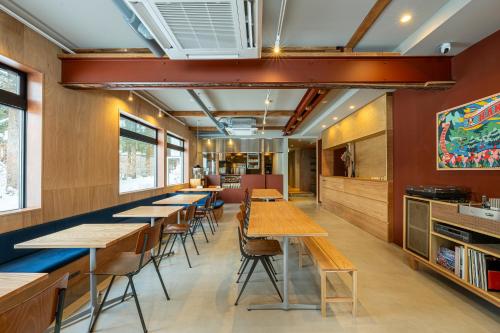 a row of tables and chairs in a restaurant at B and D HAKUBA IWATAKE in Hakuba