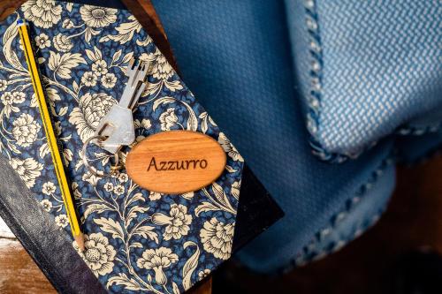 a blue tie with a wooden button with the word avalaho at Tenuta di Montemassi Fattoria in Montemassi