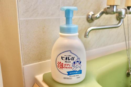a bottle of bleach sitting on a sink in a bathroom at イトノ-itono- in Goto