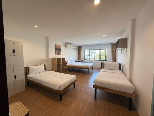 a hospital room with two beds and a couch at La Vida Hostel Chiang Mai in Chiang Mai