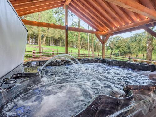 a hot tub with water coming out of it at Groudd Hall in Cerrigydrudion