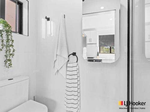 a bathroom with a toilet and a towel rack at Iluka Magic in Iluka