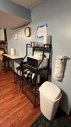 a room with a toilet and a table and a counter at MidwestBNB Room1, quite cabin in the wood vibes in Minneapolis