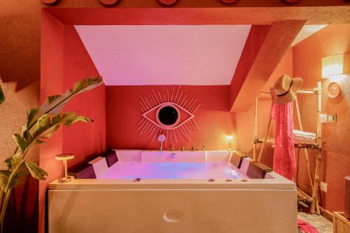 a bathroom with a large tub with a eye on the wall at Casa Superfly 2BHK with Rooftop Jacuzzi & Terrace Deck Excellent Location Boilermaker Thalassa in Oxel