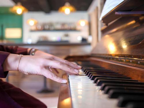 a person playing a piano with their hand on the keys at greet Hotel Belleville en Beaujolais A6 in Belleville-sur-Saône
