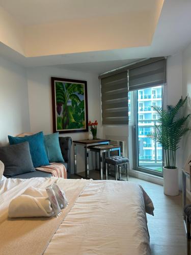 a bedroom with a bed and a couch and a table at Mekeni Azure Escape in San Fernando