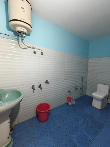 a bathroom with a sink and a toilet in it at ONLY CAFE Hotel in Chopta