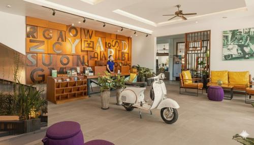 a scooter parked in a room with a salon at Grand Yard La Residence in Siem Reap