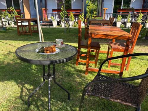 a table with a cup and a plate of food on it at Mook Raya Resort in Ko Mook