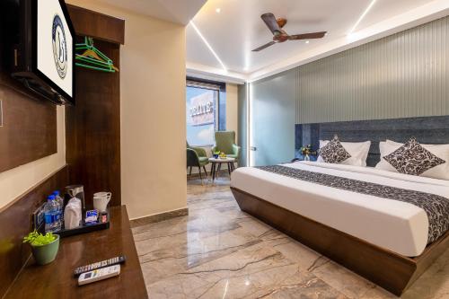 a hotel room with a bed and a tv at The Vanson Delite "Newly Rebuilt 2026" - Near New Delhi Station & Connaught Place in New Delhi