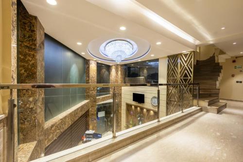 a lobby with a staircase and a circular ceiling at The Vanson Delite "Newly Rebuilt 2026" - Near New Delhi Station & Connaught Place in New Delhi