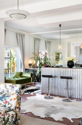 a living room with a couch and a table at Poseidon Guest House in Hout Bay
