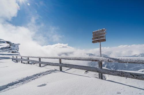 a sign on top of a snow covered mountain at Berghotel Tyrol in Senales