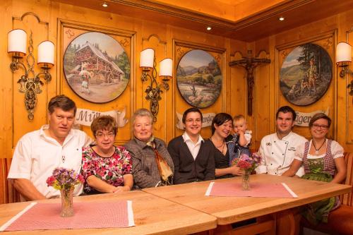 a group of people sitting at a table at Hotel Tannenmühle in Grafenhausen